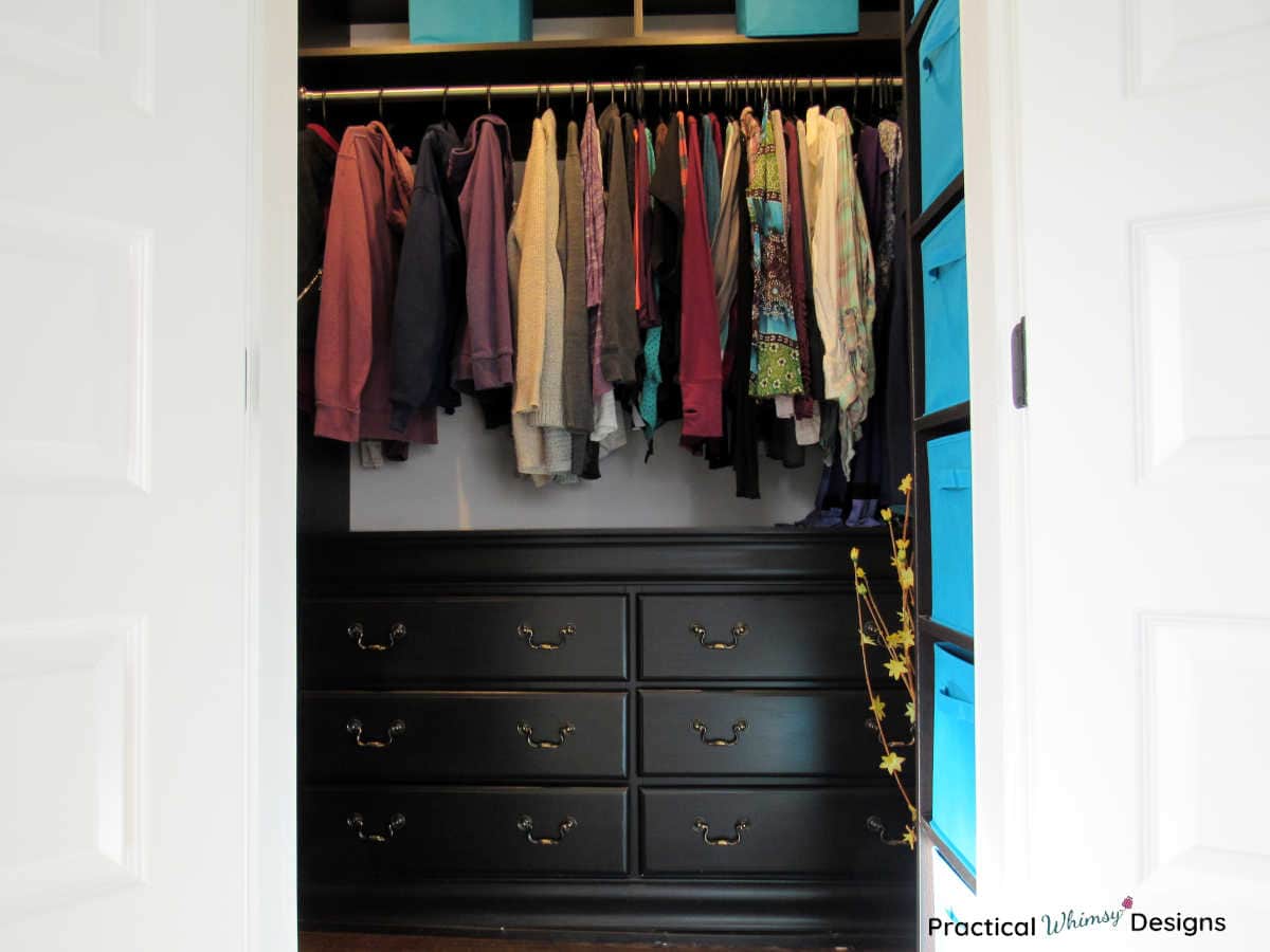 Master closet reveal with hanging clothes and built in dresser