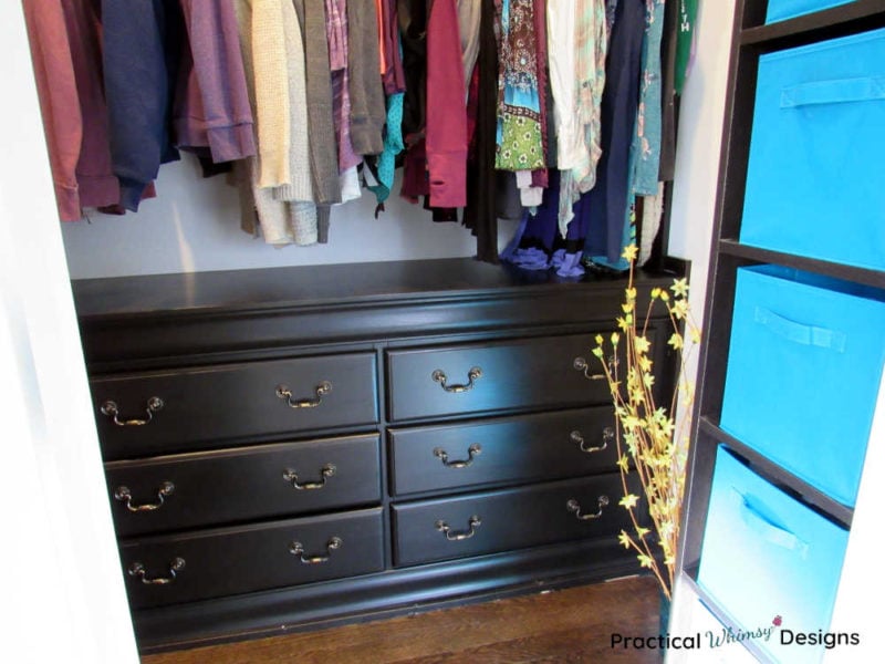 Master closet with hanging clothes and dresser