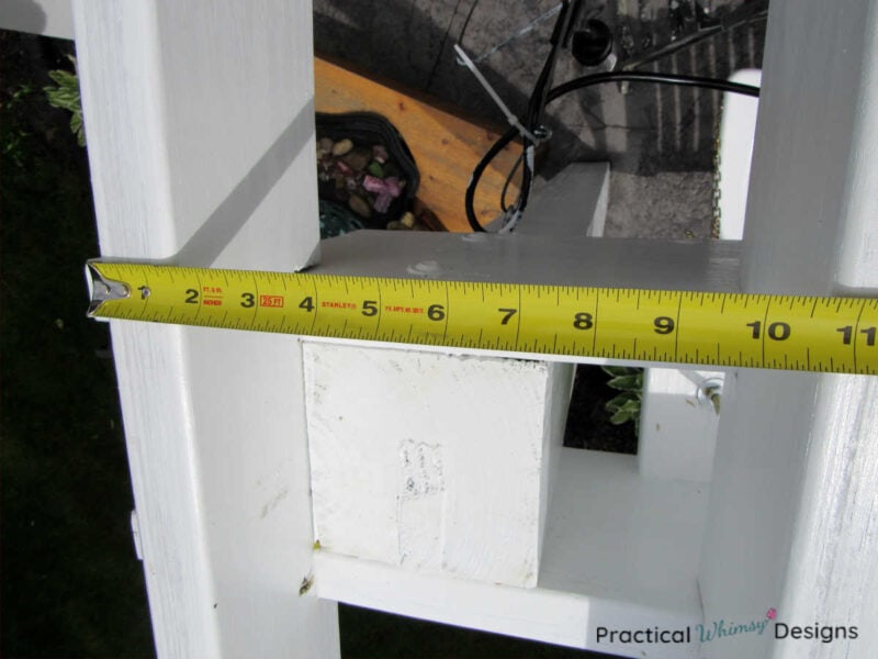 Measuring between the two pergola rafters.