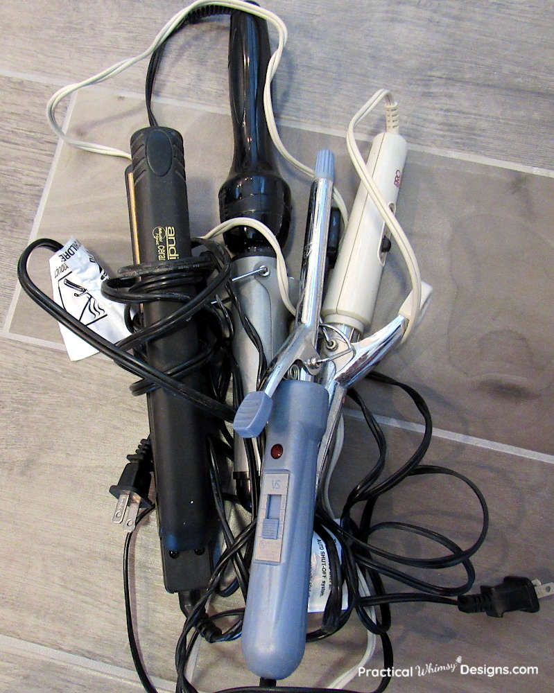 Pile of curling irons on floor