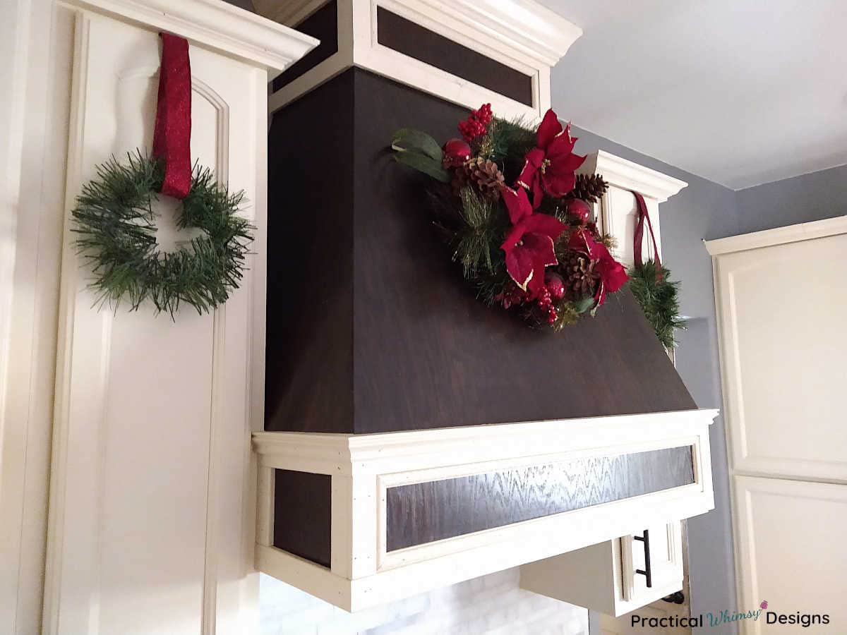 Cabinet wreaths with red ribbon in kitchen.