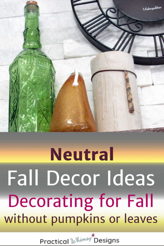 Neutral fall decor of vases and candles on shelf.