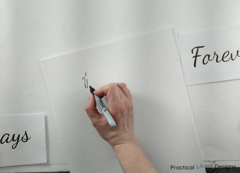 Tracing words onto canvas with a permanent marker.