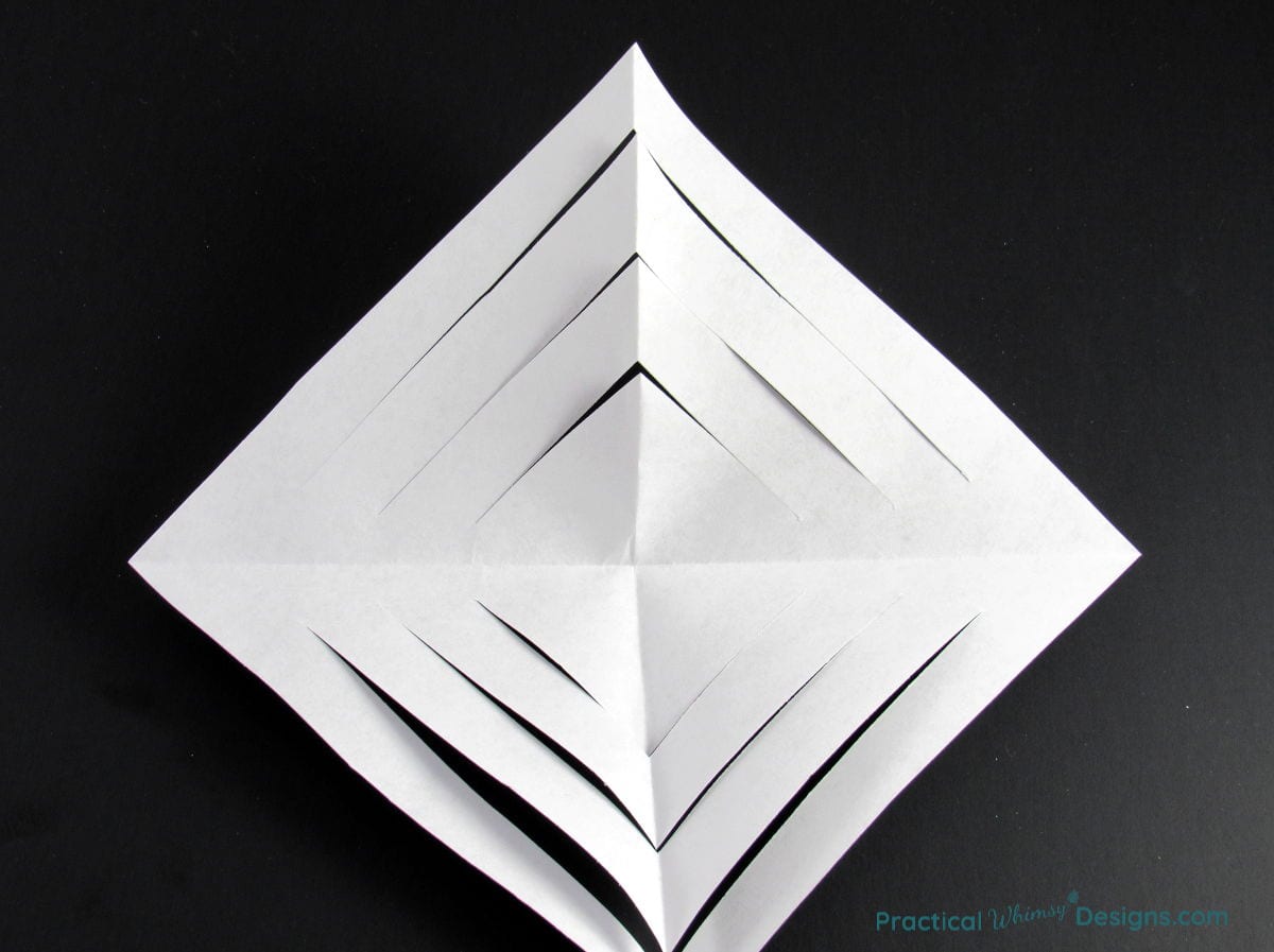 Paper square with triangle slits cut in it