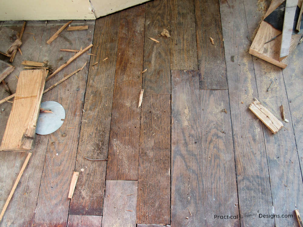 Wooden floor patched in with better floor boards to fix holes.