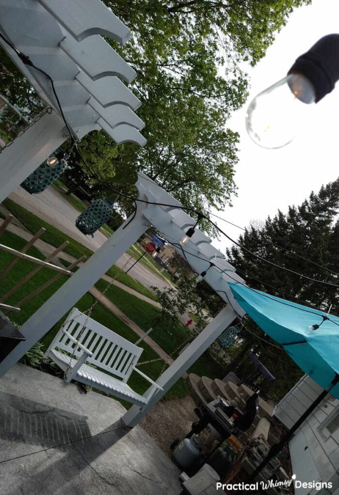 White wood pergola with swing.