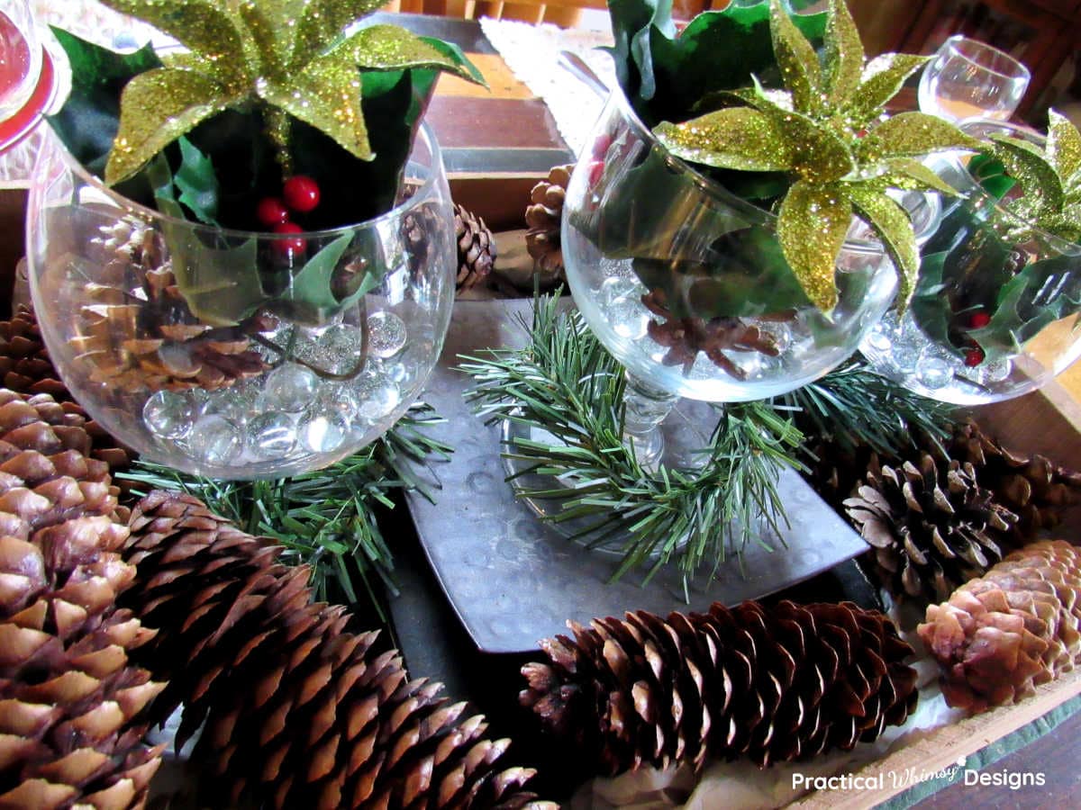Easy Christmas Pinecone Centerpiece with glasses and golden flowers in crate