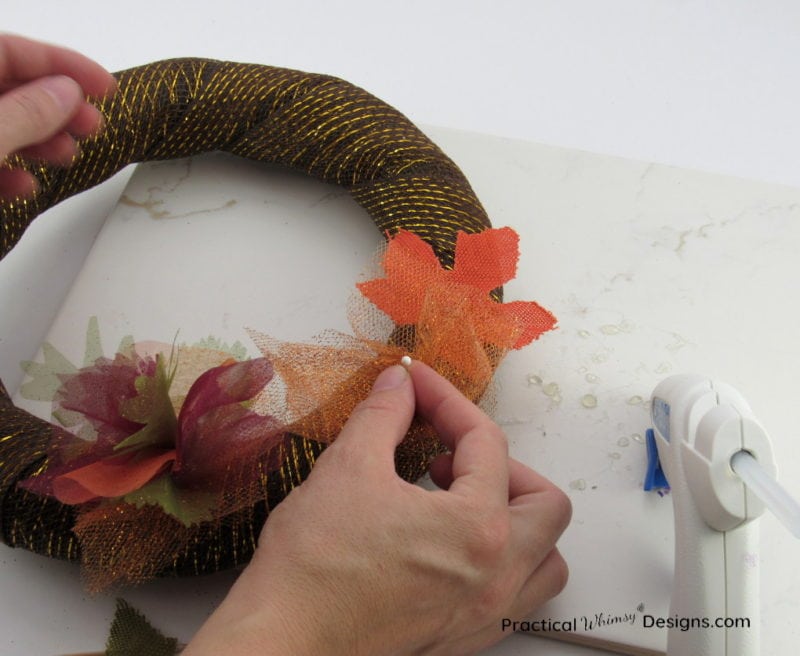 Pinning orange tulle on this simple DIY fall wreath