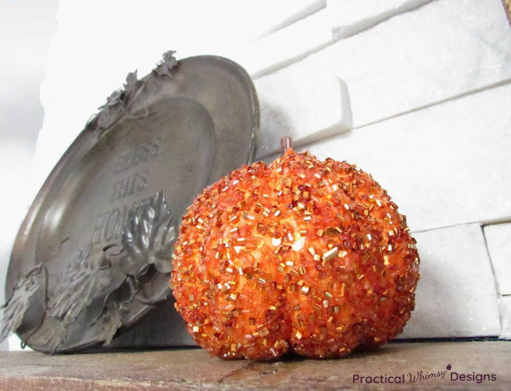 Orange sparkly pumpkin with decorative plate.