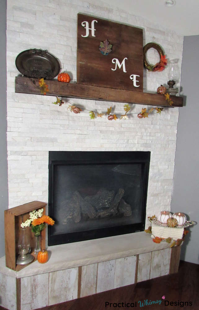 Fall mantel decor: rustic wood signs, pumpkins, and wreaths