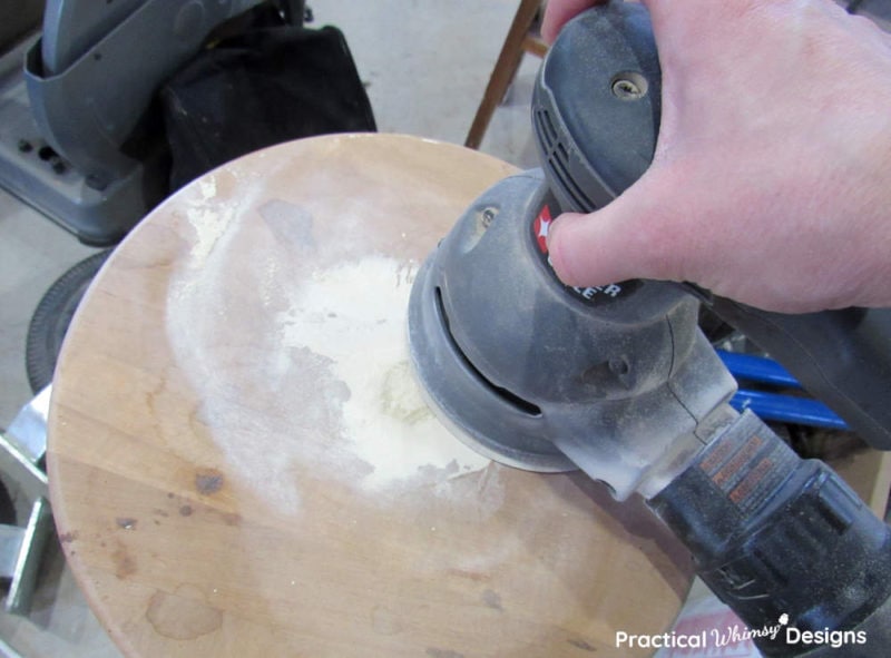 Sanding putty off table with random orbital sander.