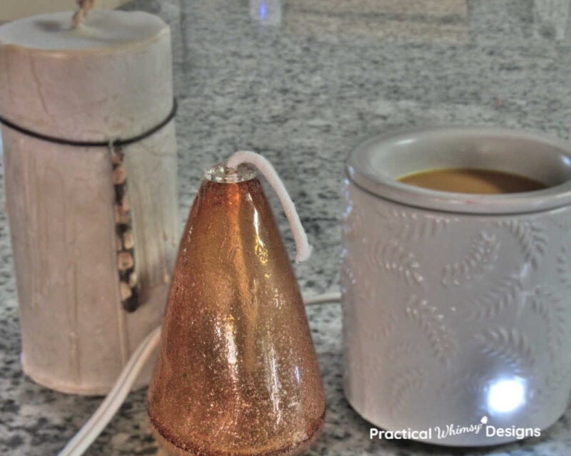 Wax burner and candles on shelf adding scent to your neutral fall decor