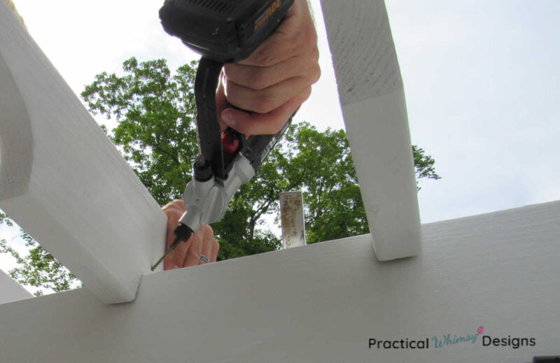 Drill screwing pergola rafter onto beam.