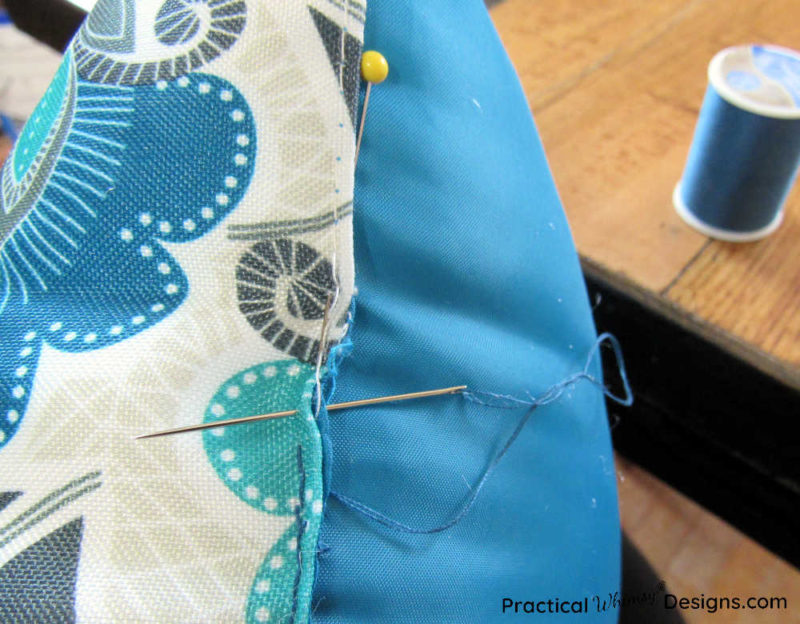 Sewing seam closed on pillow.