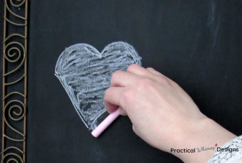 Drawing shading on heart with chalk
