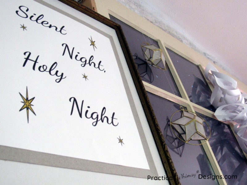 Silent night printable and stars hanging on window