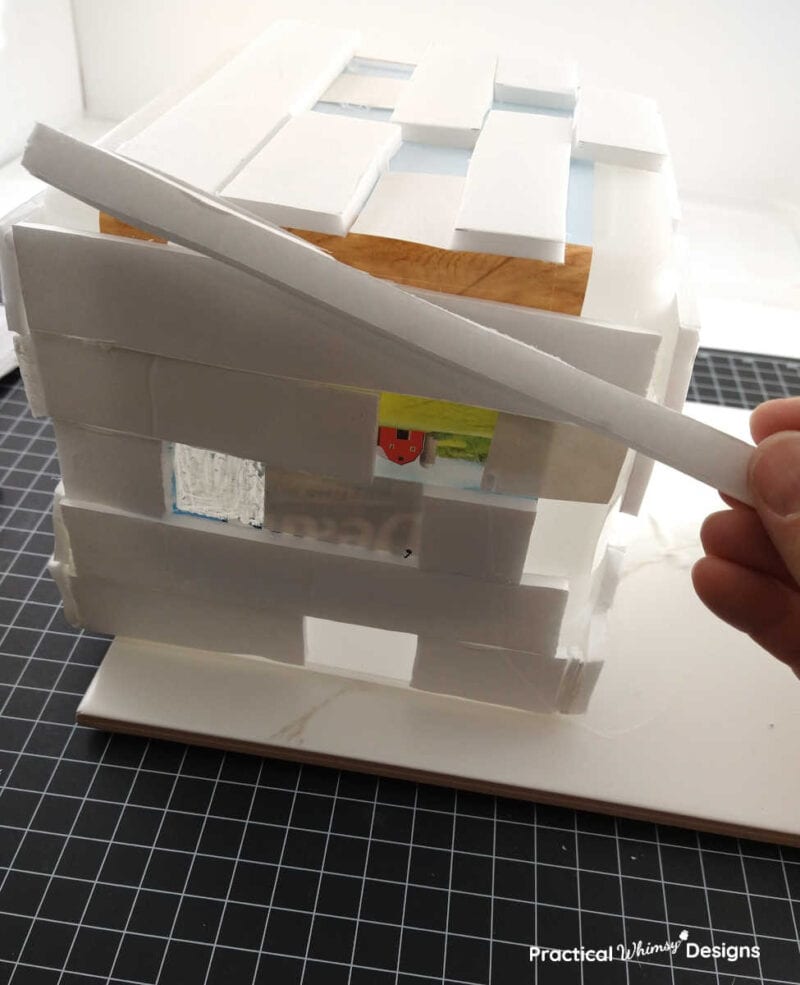 Foam board cut into a smaller strip to fit on the pixilated brick video game light.