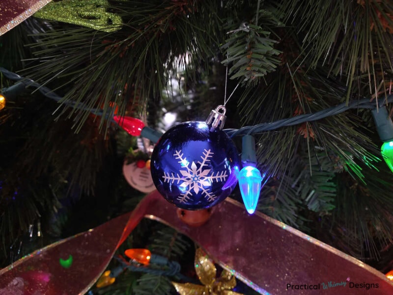 Blue snowflake ornament on tree