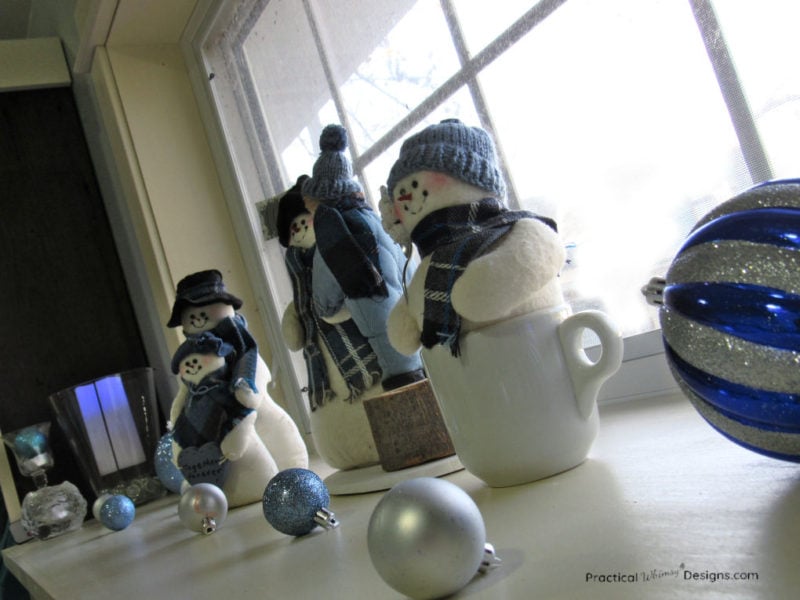 Snowmen on shelf with ornaments
