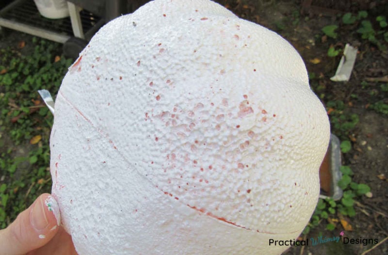 Foam pumpkin eaten away by spray paint.