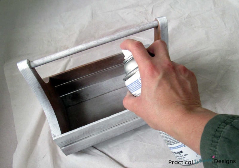 Spray painting wooden caddy with primer