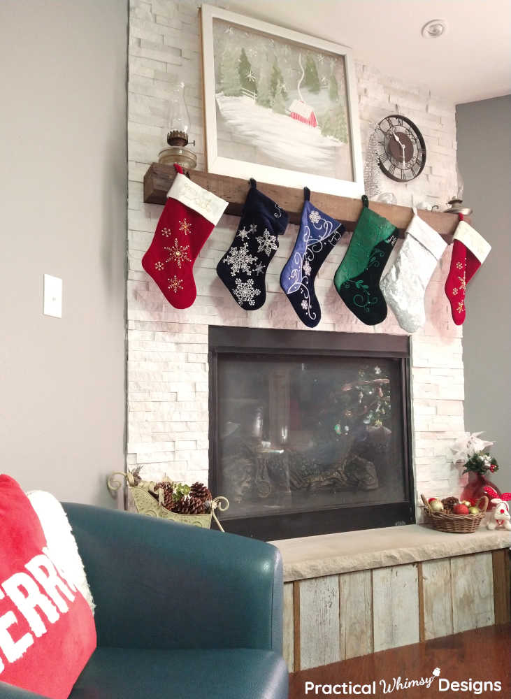 Christmas stockings hanging on the mantel over the fireplace