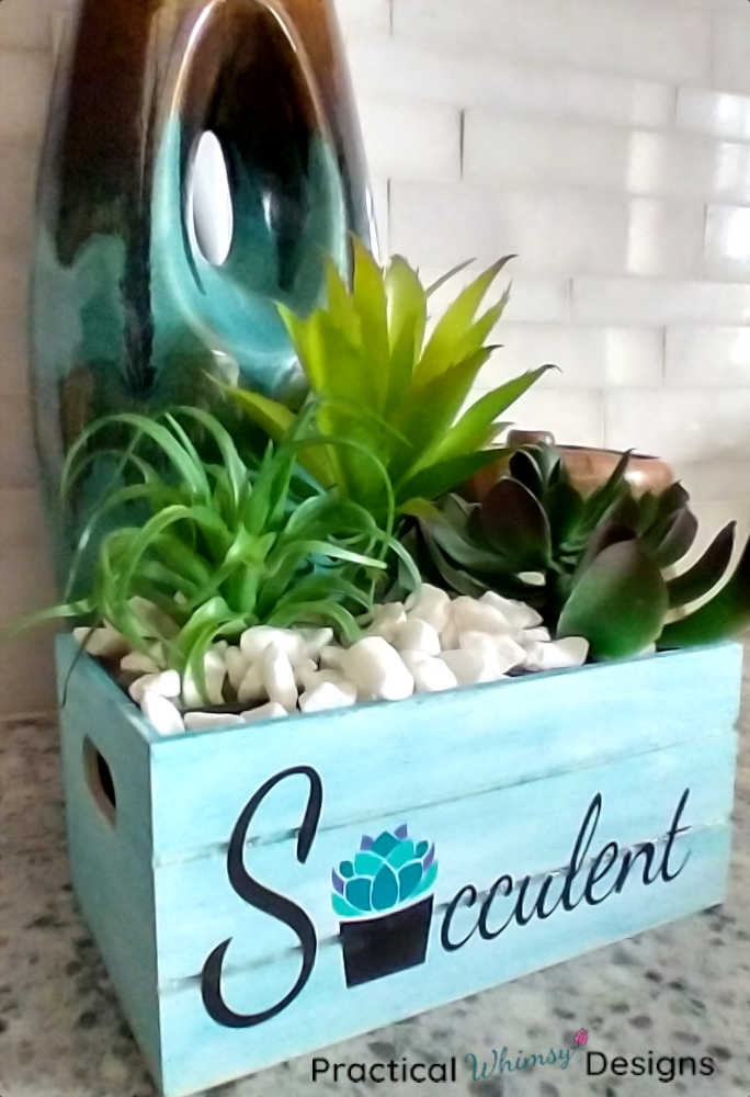 Succulent planter next to vase in kitchen