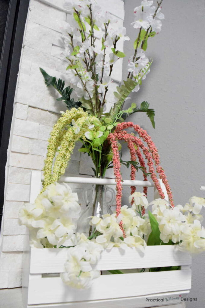 Summer flowers in vase and white caddy.