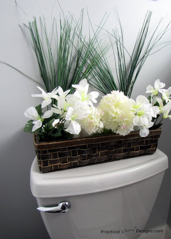 Toilet paper in a basket with flowers