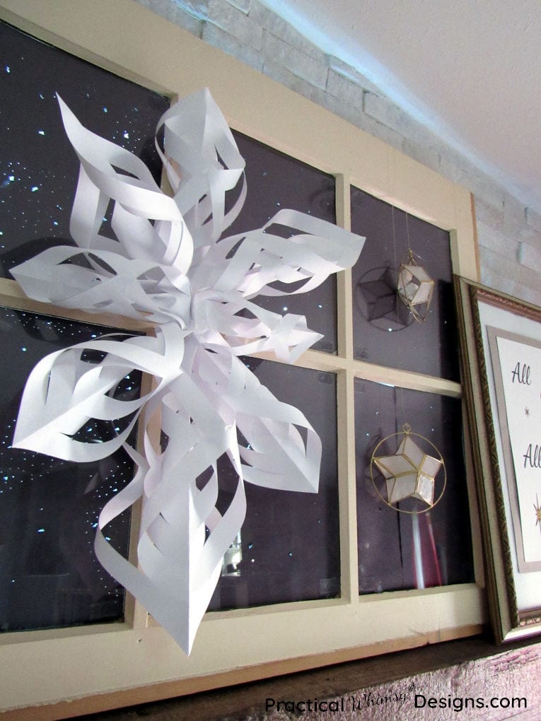 Twisted paper star hanging on window