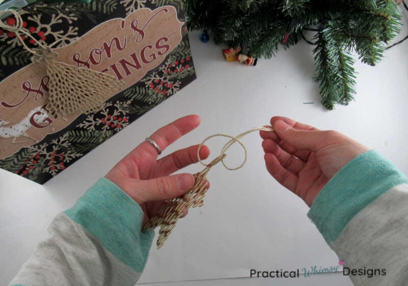 Tying hemp cord onto ornament.