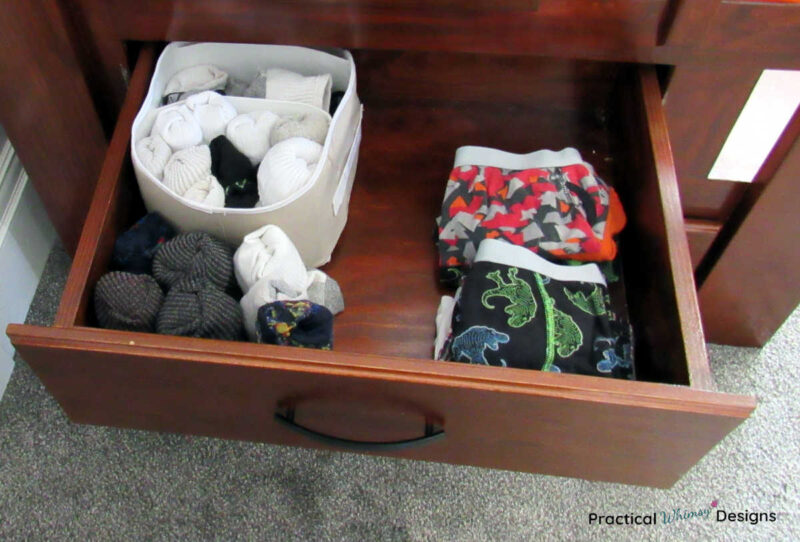 Underwear and socks folded and organized in a drawer.