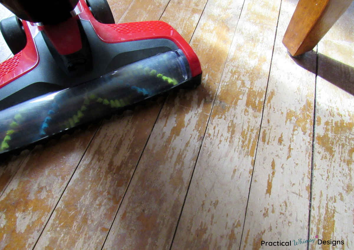 Red vacuum on hardwood floor