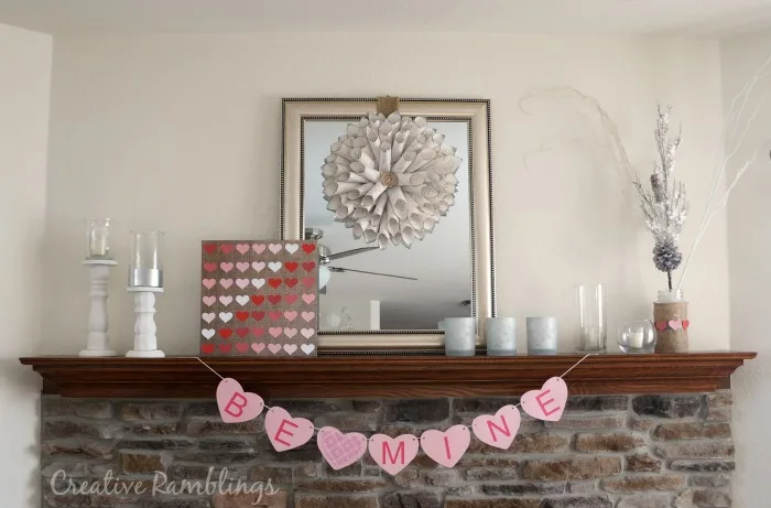 Hearts paper crafts for Valentine's day displayed on mantle.