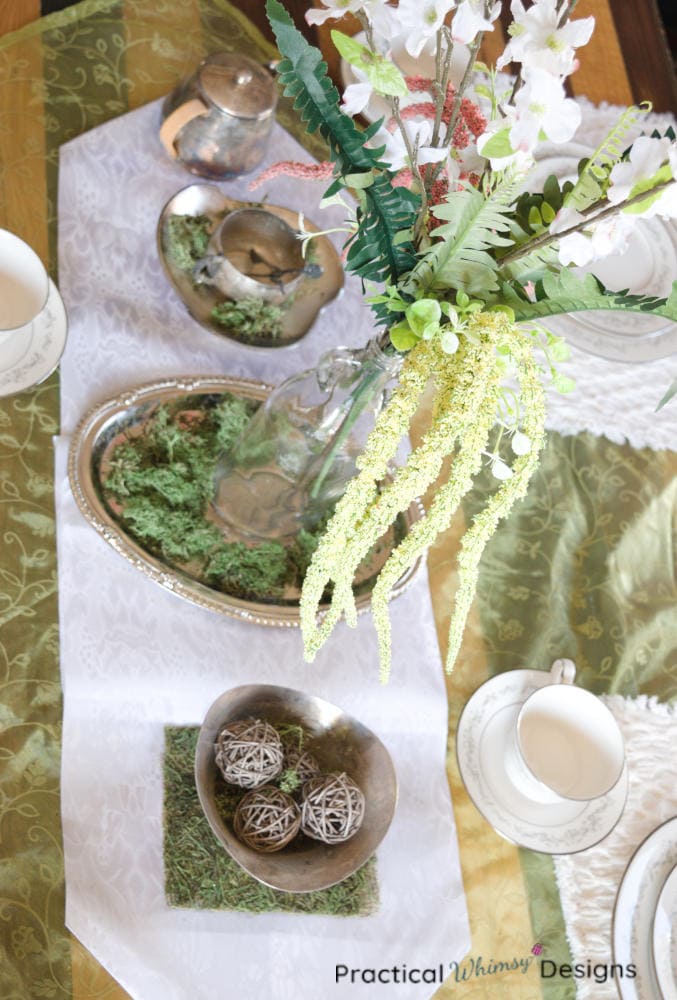 Floral vintage centerpiece idea with flowers and silver vessels