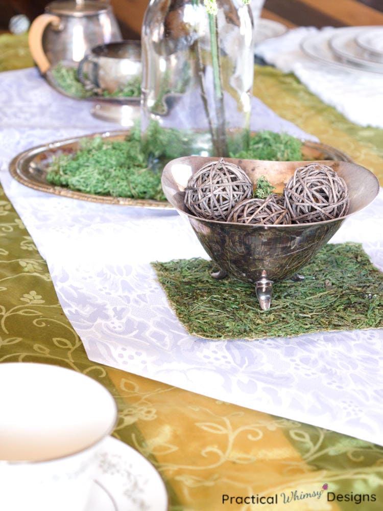 Silver bowl filled with moss and rattan balls