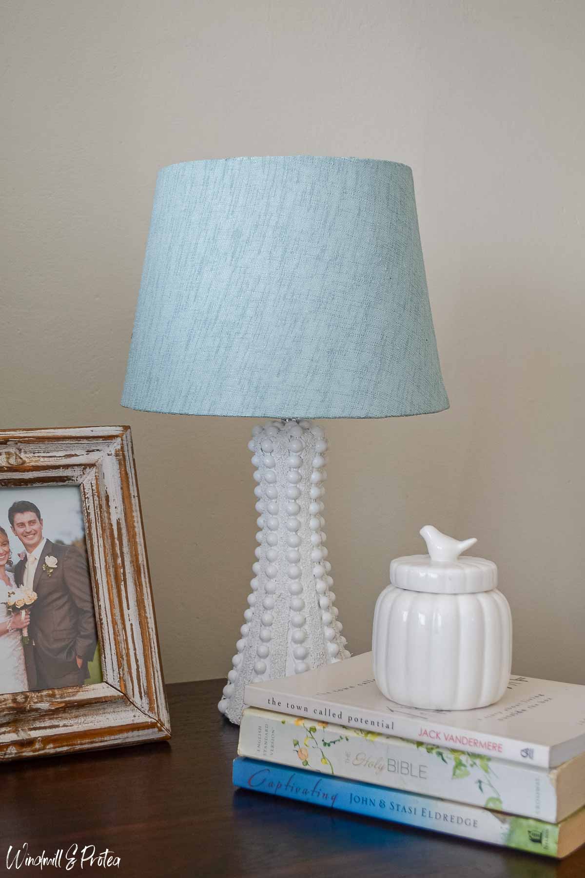 Hobnail table lamp, books and picture