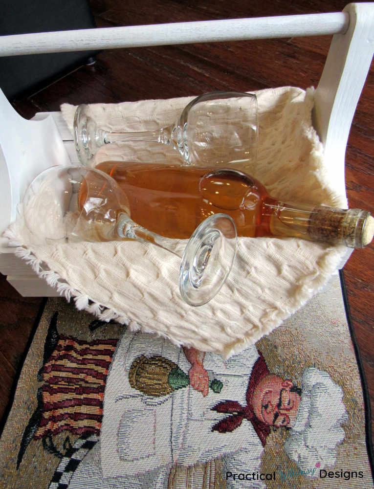 White wine and wine glasses in a wooden crate