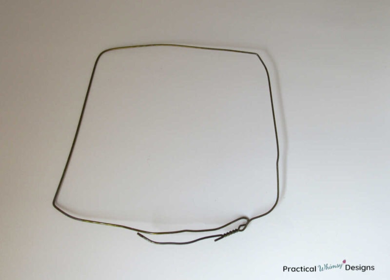 Wire hanger bent into a square shape.