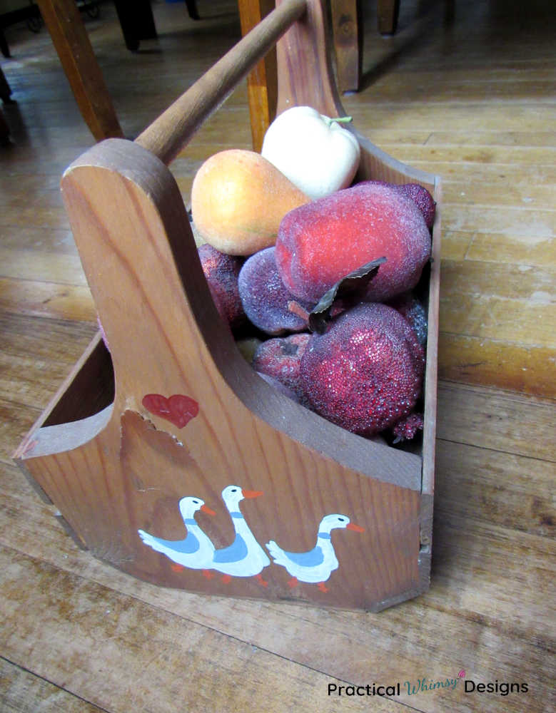 Wooden caddy with fake fruit in it