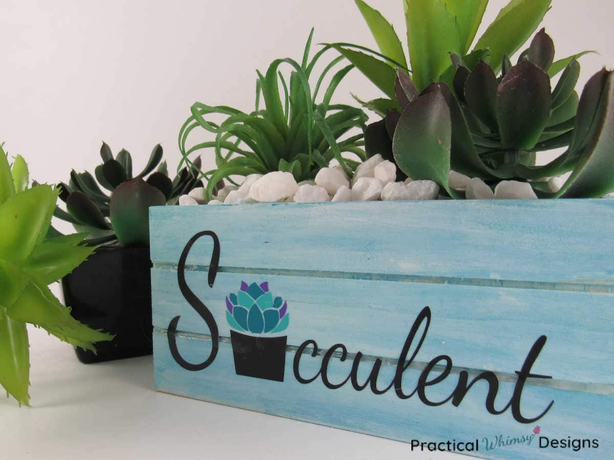 Blue succulent planter box diy with succulents plants and white rocks