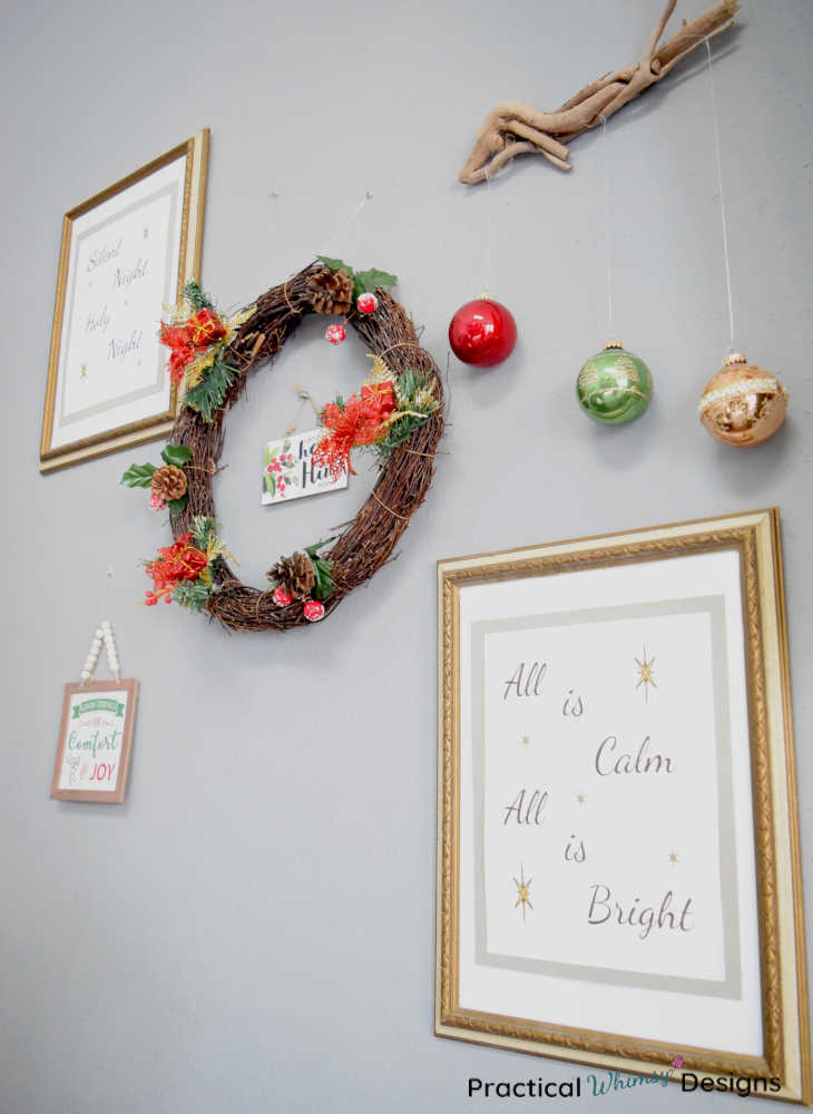 Christmas wall gallery with wreath, pictures, and ornaments.