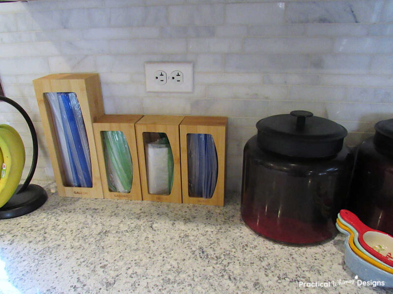 Ziplock bags in bamboo organizer on kitchen counter.